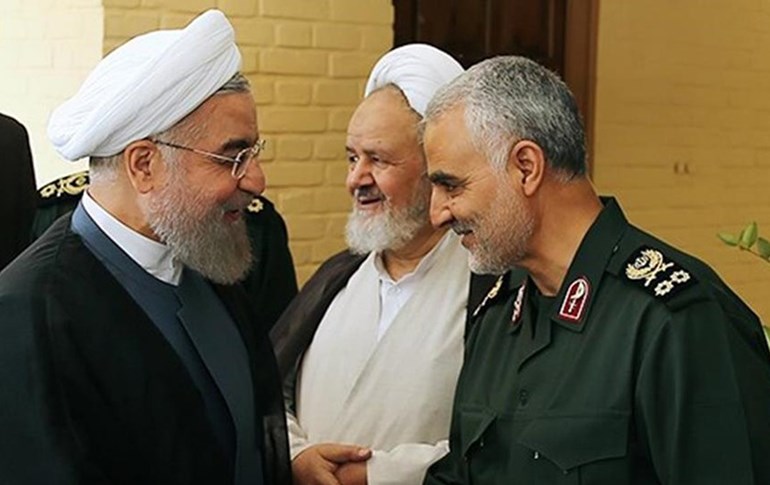 Iranian President Hassan Rouhani (left) and Gen. Qasem Soleimani (right) shake hands. File photo: Iran presidency