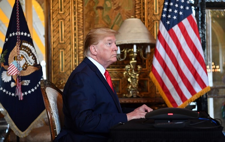 US President Donald Trump makes a video call to the troops stationed worldwide at the Mar-a-Lago estate in Palm Beach Florida, on December 24, 2019. Photo: Nicholas Kamm / AFP