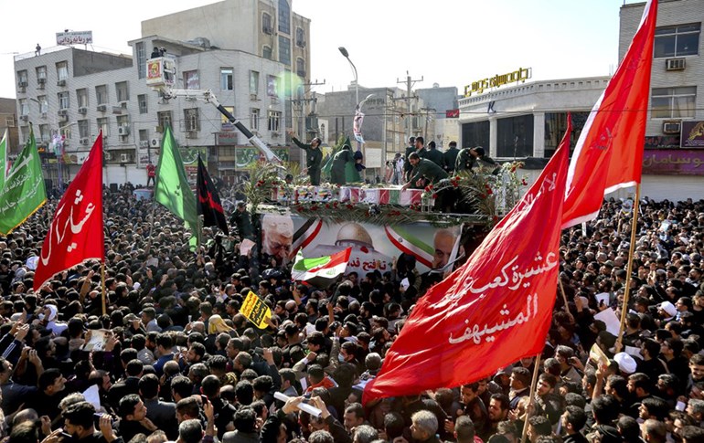 Flag draped coffins of Gen. Qassem Soleimani and others killed in Iraq in a U.S. drone strike, carried on a truck surrounded by mourners in Ahvaz, Iran, Sunday, Jan. 5, 2020. Photo: Alireza Mohammadi/ISNA via AP