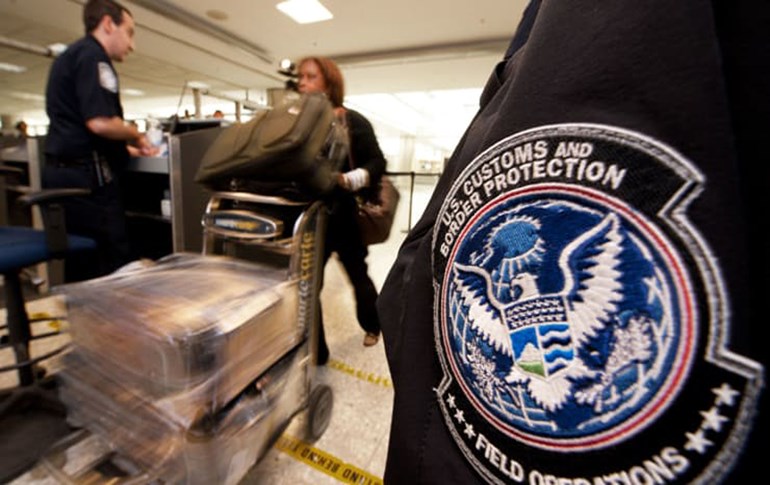 An international air traveler is cleared by a U.S. Customs and Border Protection Officer inside the U.S. Customs and Immigration area at Dulles International Airport. Photo; AFP/Paul J. Richards