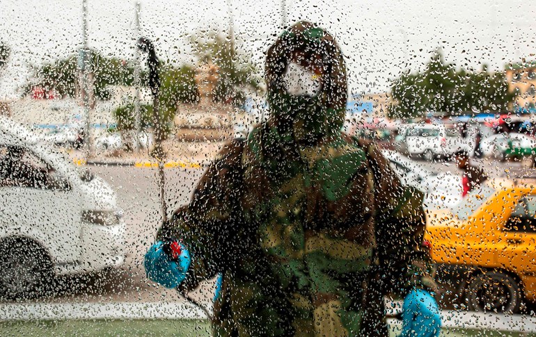 Civil defence workers disinfect a window in the Ashar district of Iraq's southern city of Basra, March 7, 2020. Photo: Hussein Faleh / AFP