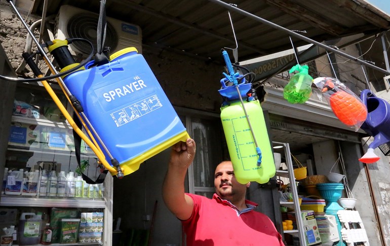 A man displays items to sell to disinfect against COVID-19 in Baghdad on March 11, 2020. Photo: AFP