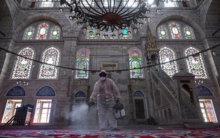 A member of Istanbul's Municipality disinfects the Mihrimah Sultan Mosque in Istanbul to prevent the spread of the COVID-19 on March 13, 2020. Photo: Ozan Kose/AFP