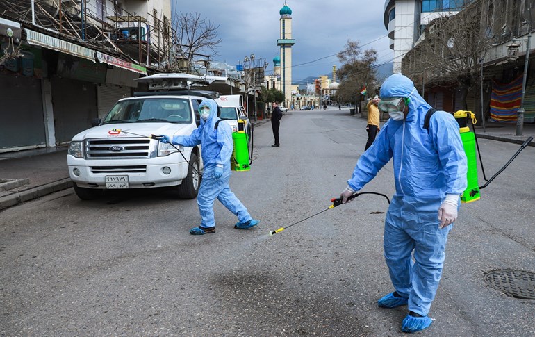 Health workers disinfect streets of Sulaimani on March 14. Photo: Shwan Mohammed/ AFP