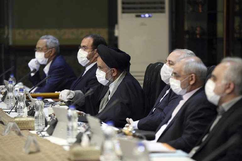 Office of the Iranian Presidency, cabinet members wearing face masks and gloves attend their meeting in Tehran, Iran, Wednesday, March 18, 2020. Photo: Office of the Iranian Presidency via AP