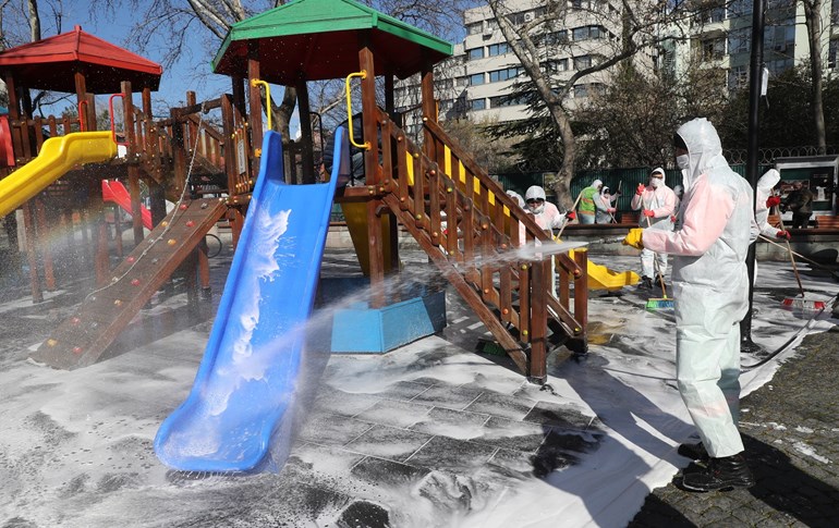 Disinfection works are being carried out by officials, wearing protective suits, at Kugulu Park as part of precautions against the coronavirus (COVID-19), on March 17, 2020 in Ankara. Photo: Adem Altan
