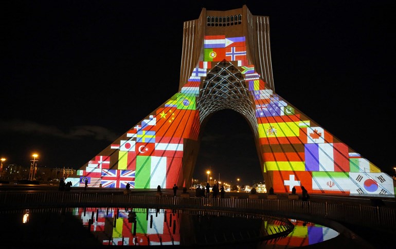 Iran’s Azadi (Freedom) Tower is lit up with flags and messages of hope in solidarity with all countries affected by the COVID-19 pandemic, Tehran, March 31, 2020. Photo: STR / AFP