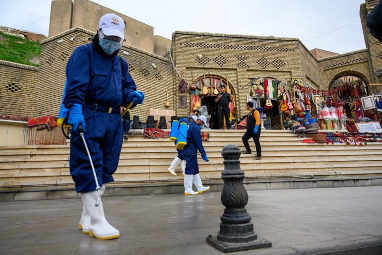 Municipal worker sanitizes the streets of Erbil. Photo: Bilind T. Abdullah