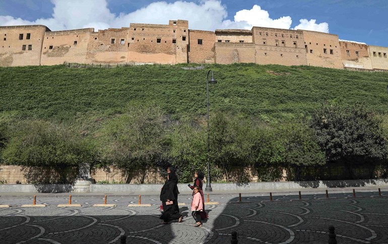 Women walk on an empty street by Erbil citadel on March 30, 2020. Photo: Safin Hamed/AFP