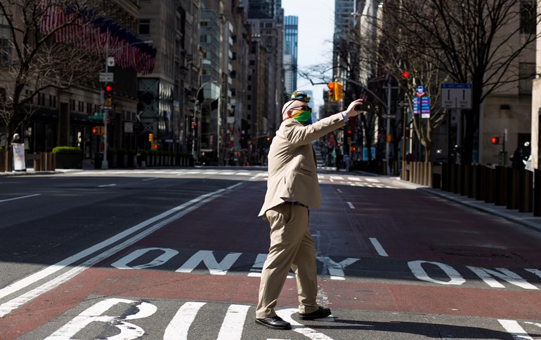 A man wearing an Easter suit and face mask records a video in front of New York's Saint Patrick Cathedral on April 12, 2020. Photo: Kena Betancur / AFP