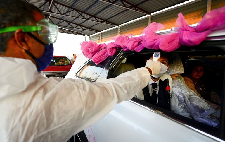 An Iraqi groom has his temperature tested at a drive through testing centre for coronavirus (COVID-19) in Iraq's central city of Hilla on April 13, 2020. Photo: Haidar Hamdani/ AFP