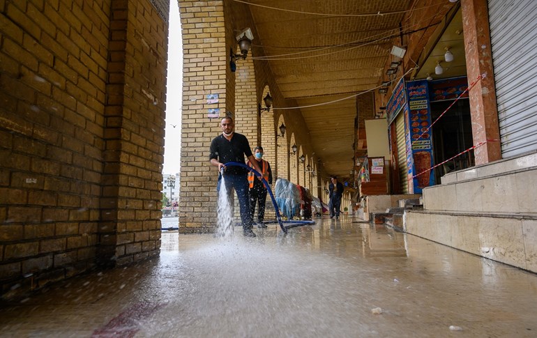 Man cleans path infront of closed shops near the Erbil citadel. Photo: Bilind T. Abdullah/ Rudaw