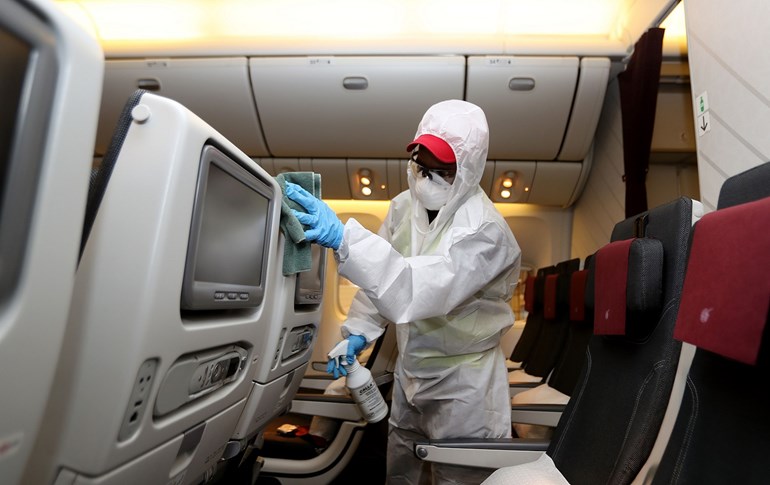 An employee sanitises passenger seats inside an aircraft at Hamad International Airport in Doha, Qatar, April 1, 2020. File photo: Karim Jaafar / AFP