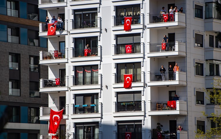 People celebrate with Turkish flags on their balconies in Istanbul to mark the National Sovereignty and Children's Day on April 23, 2020. Photo: Yasin Akgul / AFP