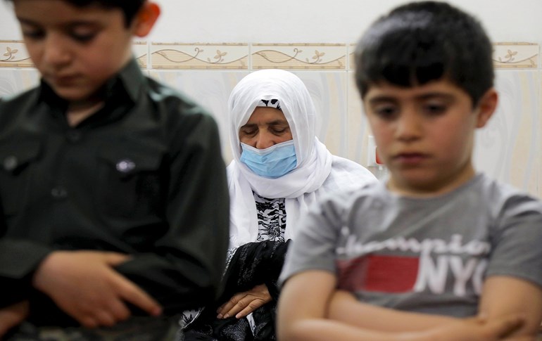 An Iraqi Kurdish family prays in their home on the first day if the Muslim holy month of Ramadan on April 24, 2020, in Erbil. Photo: Safin Hamed