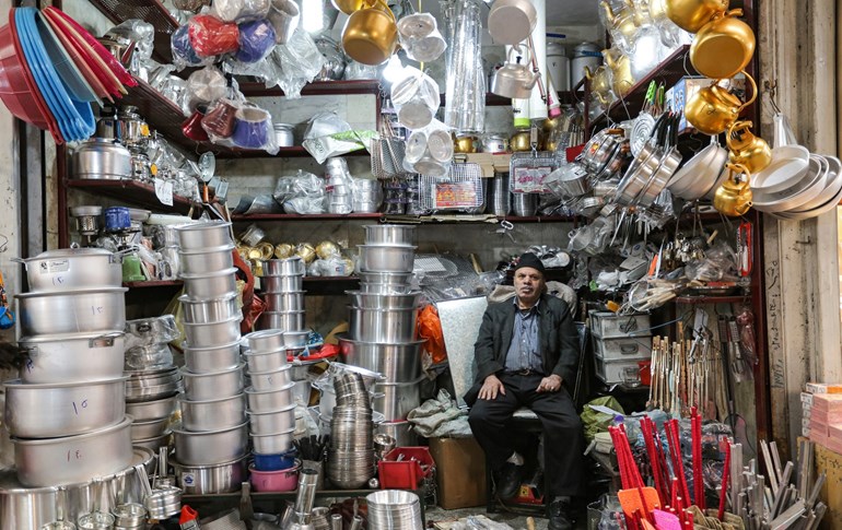 A merchant selling kitchenware sits in his shop waiting for customers in Tajrish Bazaar in Iran's capital Tehran on April 25, 2020 during the Muslim holy month of Ramadan. Photo: Atta Kenare/ AFP