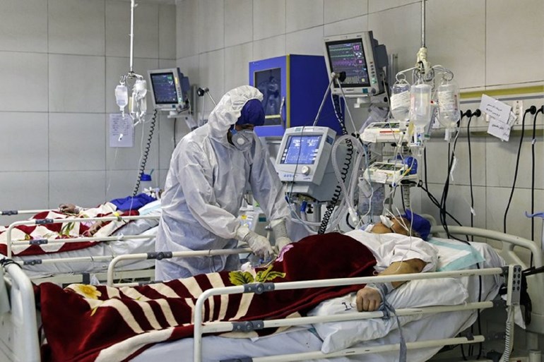 In this March 1, 2020 file photo, a medic treats a patient infected with coronavirus, at a hospital in Tehran, Iran. Photo: Associated Press