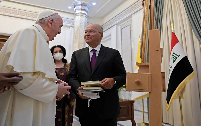 Iraqi President Barham Salih offers books and other gifts to Pope Francis during his visit to the presidential palace in Baghdad on March 5, 2021. Photo: AFP/HO/Vatican Media