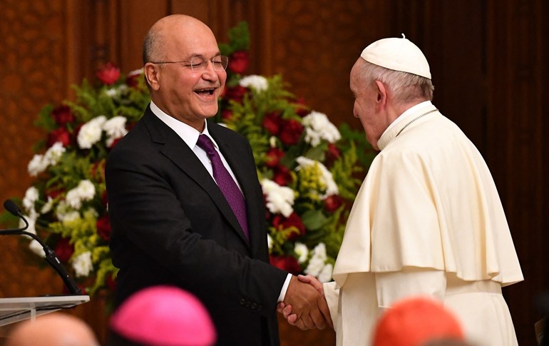 Pope Francis shakes hands with Iraqi President Barham Salih at the presidential palace in Baghdad on March 5, 2021. Photo: Vincenzo Pinto/ AFP