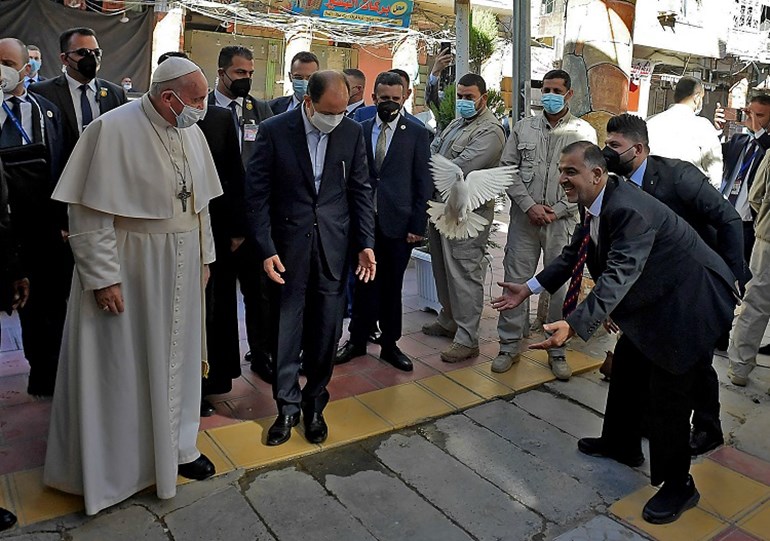 A handout picture provided by the Vatican media office shows Pope Francis being welcomed upon his arrival in the Iraqi shrine city of Najaf, on March 6, 2021. Photo: Stringer / Vatican Media / AFP