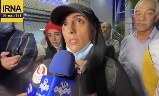 Iranian rock climber who competed without hijab returns home