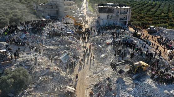 An aerial picture shows rescuers searching the rubble of buildings for casualties and survivors in the village of Besnaya in Syria's rebel-held northwestern Idlib province at the border with Turkey following an earthquake, on February 7, 2023. Photo: Omar Haj Kadour/AFP