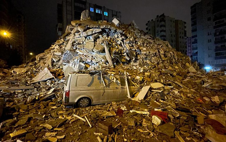 A vehicle caught under the rubble of a building in Turkey destroyed by a massive earthquake on february 6th, 2023. Photo/Anadolu Agency