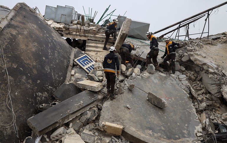 Members of the Syrian civil defence, known as the White Helmets search for survivors under the rubble following an earthquake in the town of Zardana on February 6, 2023. Mohammed al-Rifai/AFP