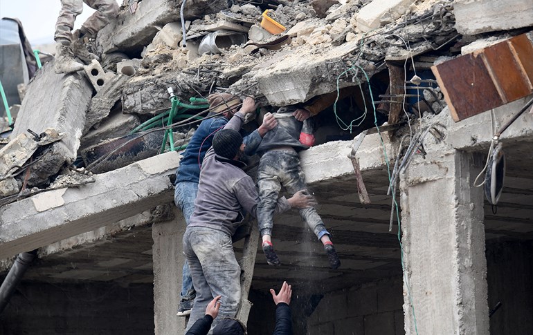 Residents retrieve an injured girl from the rubble of a collapsed building following an earthquake in the town of Jindires on February 6, 2023. Photo: AFP