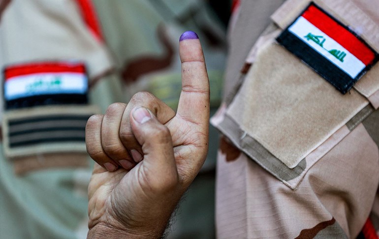 An Iraqi army soldier poses with his ink-stained finger after voting in the early round for members of the military and security forces in the 2023 Iraqi municipal elections, in Kadhimiya in northern Baghdad on December 16, 2023. Photo: Ahmad al-Rubaye/AFP