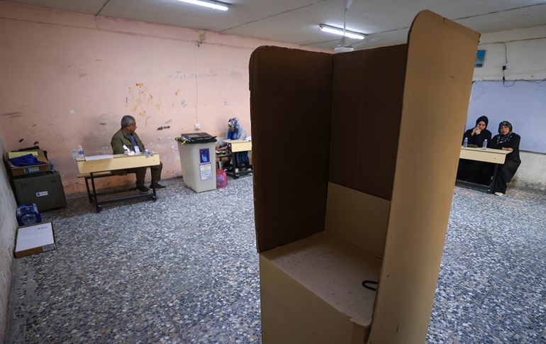 Iraqi High Election Commission staff await voters in the election hall for the first provincial council elections in a decade, at a polling station in Sadr City in the capital Baghdad, on December 18, 2023. Photo: Ahmad al-Rubaye/AFP