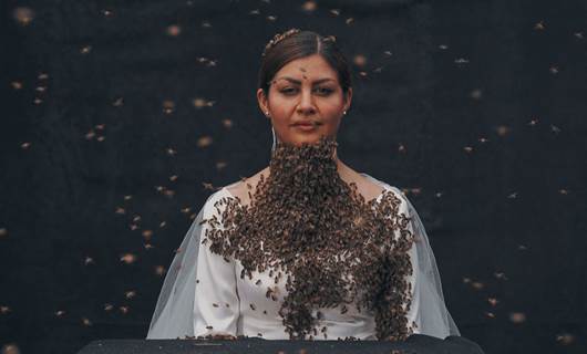 Kurdish woman covers herself with thousands of bees