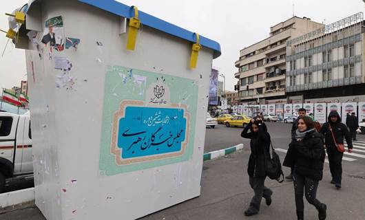 People walk in front of an installation in the form of a giant ballot box, ahead of the upcoming elections, in Tehran on February 28, 2024. Photo: ATTA KENARE/AFP