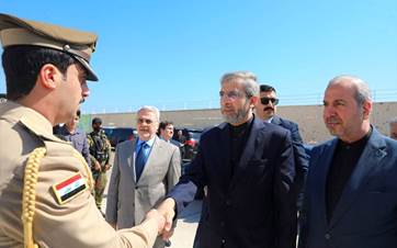 Iran’s acting foreign minister Ali Bagheri Kani (center) shakes hand with an Iraqi soldier at the memorial site of Soleimani and Muhandis near Baghdad airport on June 13, 2024. Photo: Mehr News Agency