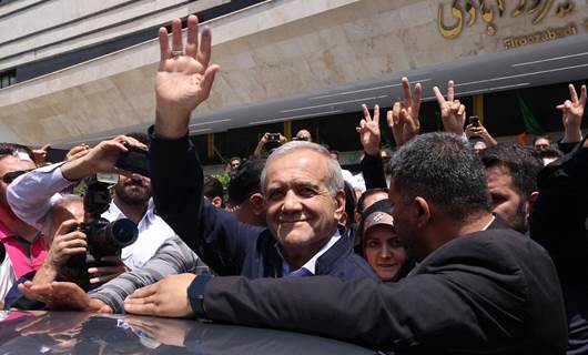Iranian presidential candidate and reformist Massoud Pezeshkian reacts to the crowd outside a polling station where he cast his vote in the presidential election in Tehran on June 28, 2024. Photo: AFP