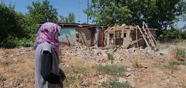 Imos Bicki, a Kurdish woman from southeast Turkey, visits the ruins of her house that was destroyed in a deadly 2020 earthquake. Photo: Rudaw
