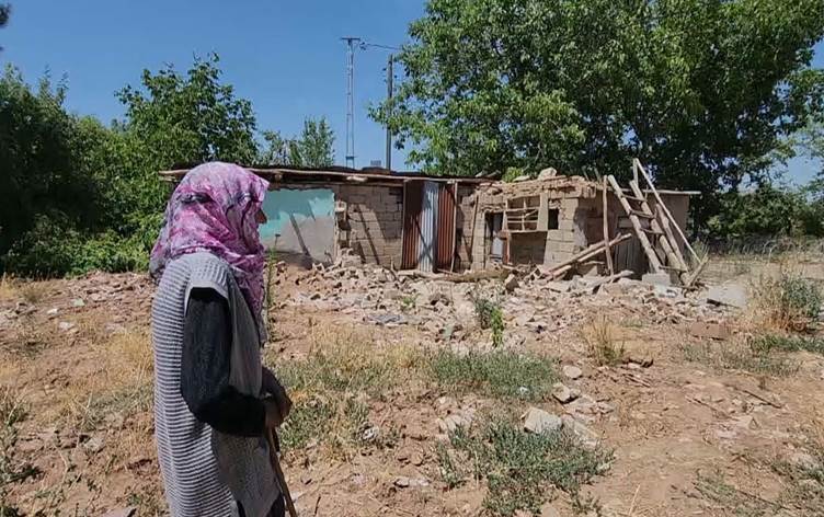 Imos Bicki, a Kurdish woman from southeast Turkey, visits the ruins of her house that was destroyed in a deadly 2020 earthquake. Photo: Rudaw