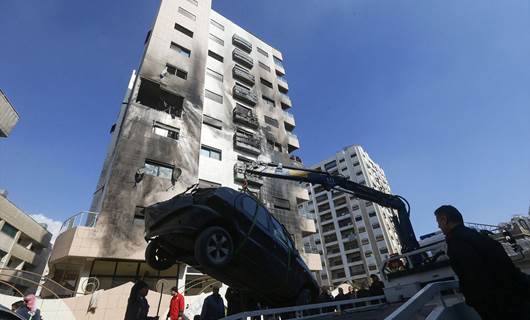 A car is removed from the area where reported Israeli air strikes targeted a residential building in the Kafr Sousa district of the Syrian capital Damascus on February 21, 2024. Photo: Louai Beshara/AFP